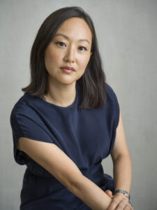 Photograph of the author, leaning in to look directly at the viewer.